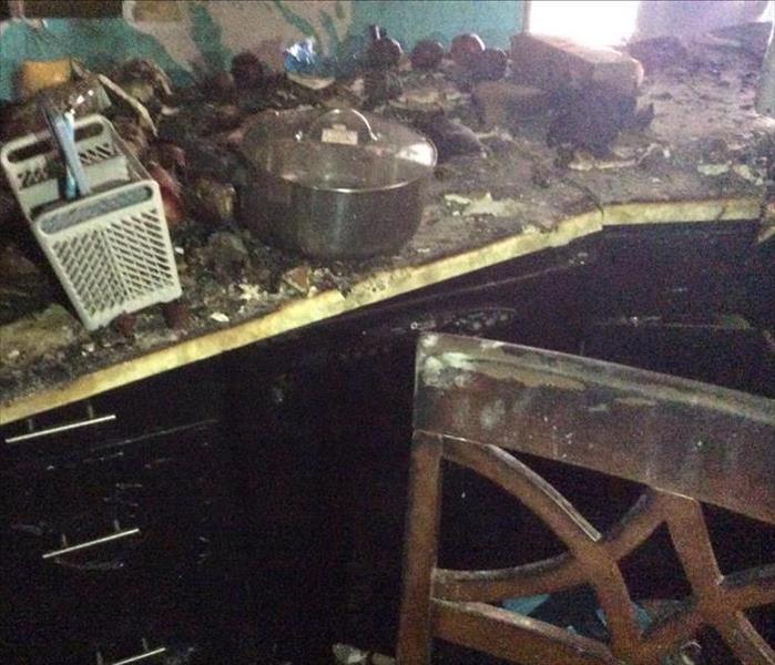 Kitchen suffered severe fire damage, pans and kitchen utensils burned to ashes