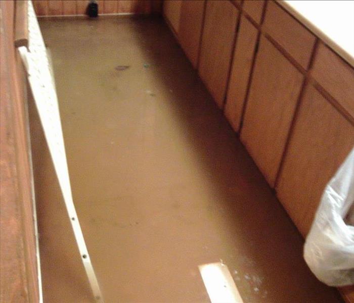Kitchen floor flooded with standing water.